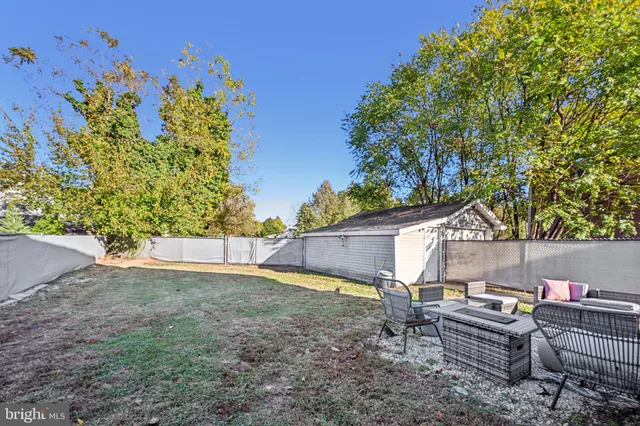 a view of a backyard with sitting area