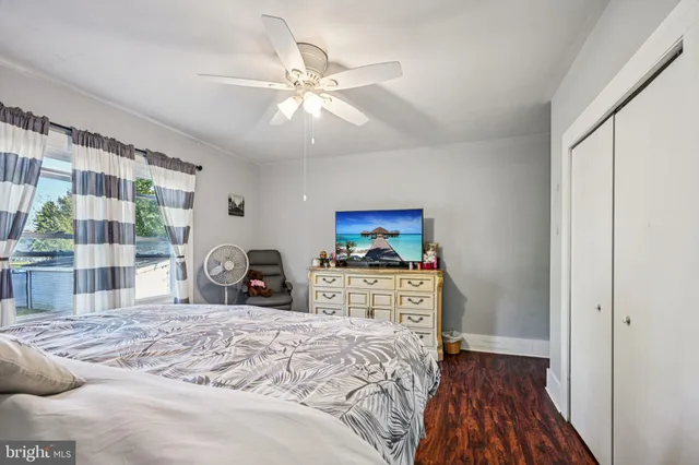 a view of a bedroom with furniture and wooden floor
