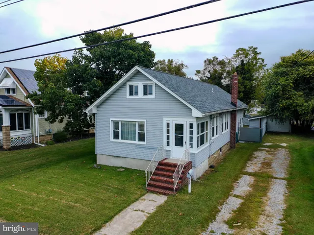 a front view of a house with a garden and porch