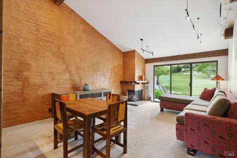 a dining room with furniture and a large window