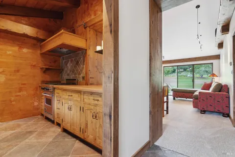 a en suite bathroom with a sink mirror and window
