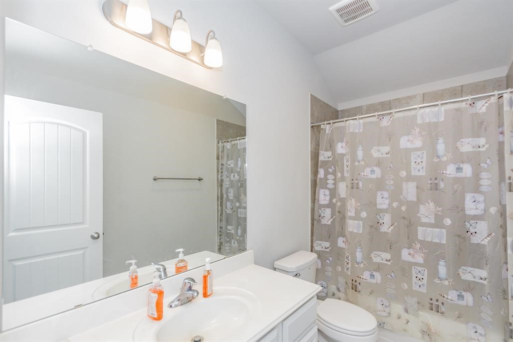 21423 Holly Heights Road Cypress, TX 77433 - Photo 7 of 12 a bathroom with a sink a toilet and shower