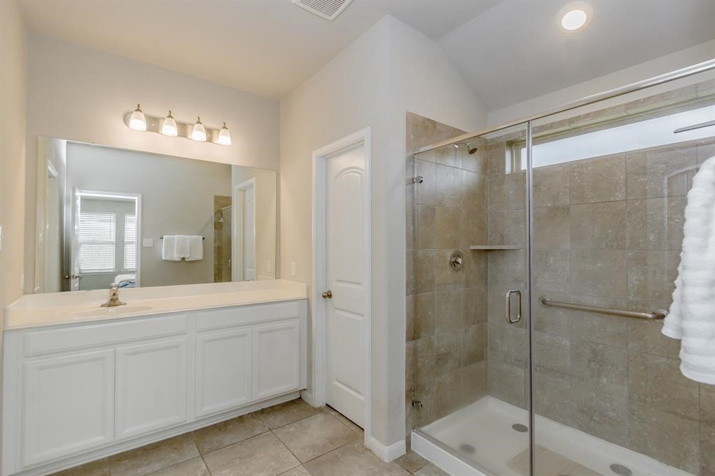 21423 Holly Heights Road Cypress, TX 77433 - Photo 8 of 12 a bathroom with a double vanity sink mirror and shower