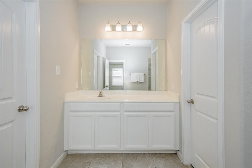 21423 Holly Heights Road Cypress, TX 77433 - Photo 9 of 12 a bathroom with a sink and a mirror