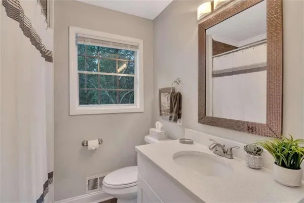 a bathroom with a sink toilet and tub