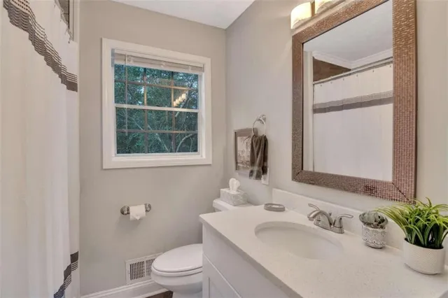 a bathroom with a sink toilet and tub