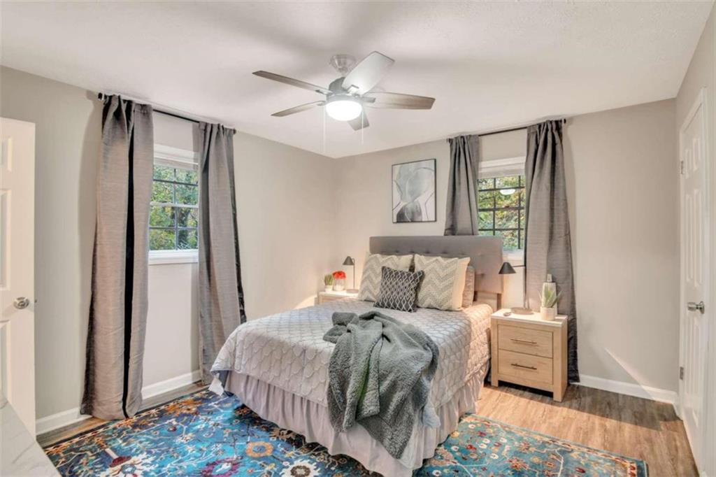 1504 Dupree Road Woodstock, GA 30189 - Photo 16 of 23 a bedroom with a large bed and a chandelier