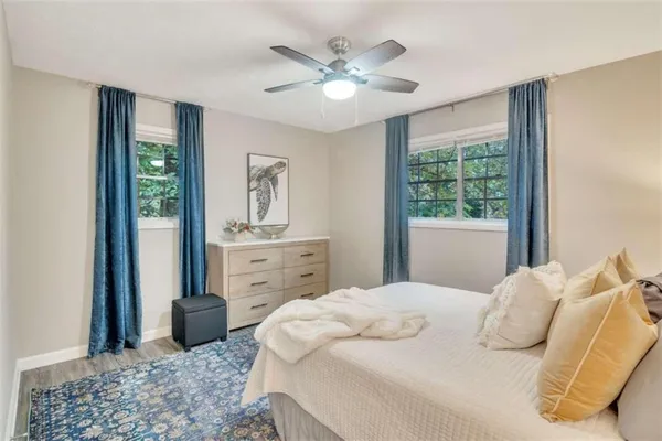 a bedroom with a large bed and a chandelier