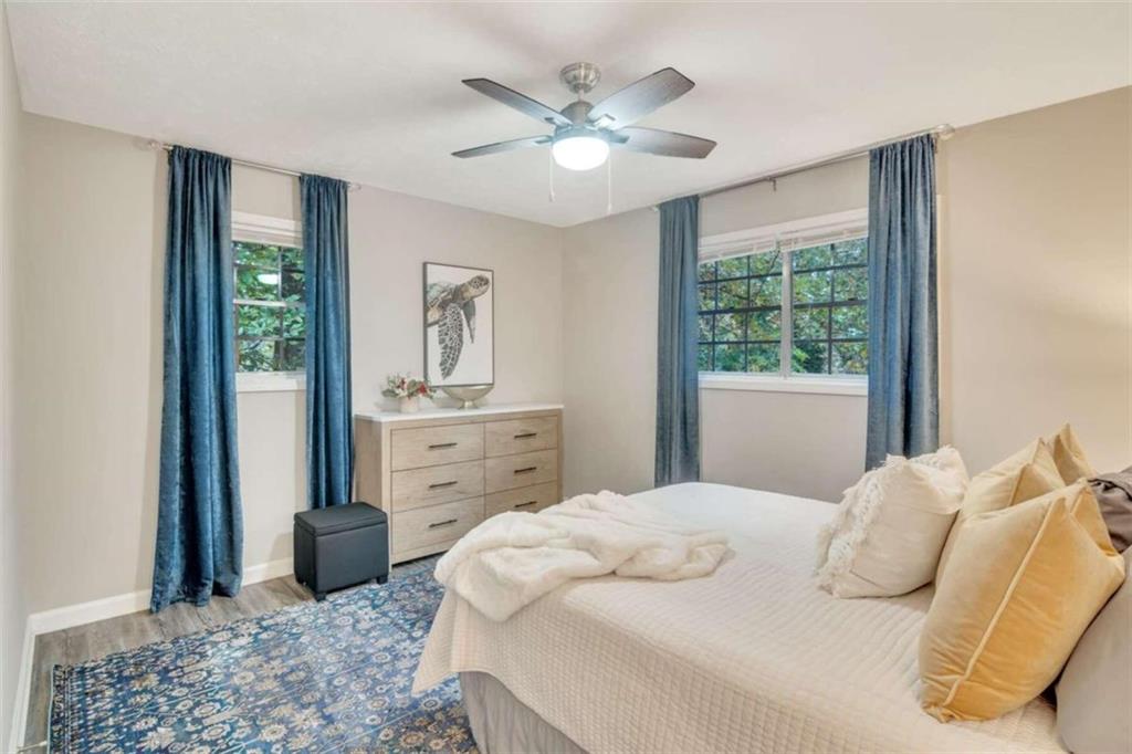 1504 Dupree Road Woodstock, GA 30189 - Photo 19 of 23 a bedroom with a large bed and a chandelier