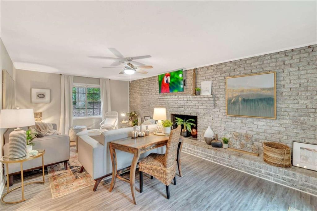 1504 Dupree Road Woodstock, GA 30189 - Photo 2 of 23 a dining room with furniture a fireplace and wooden floor