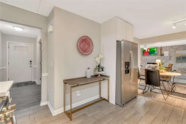 a kitchen with stainless steel appliances granite countertop a refrigerator and a stove top oven
