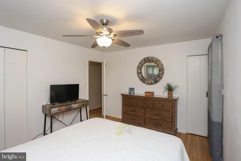 a bedroom with a bed and a television
