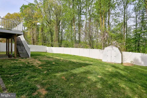 a view of backyard with swimming pool and deck