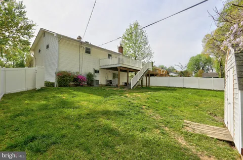 a view of house with backyard