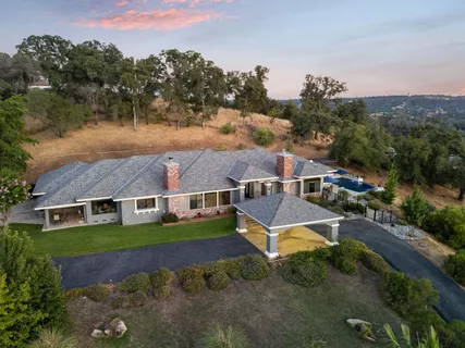 an aerial view of a house with a yard
