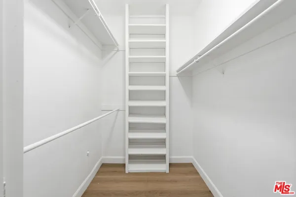 a view of walk in closet with empty racks