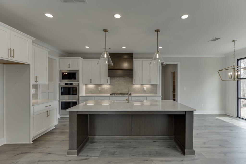 173 Swimming Pool Road Buford, GA 30518 - Photo 15 of 68 a view of kitchen with refrigerator microwave and stove