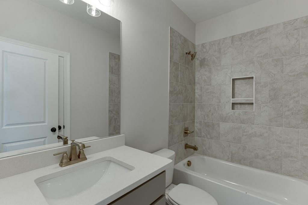 173 Swimming Pool Road Buford, GA 30518 - Photo 32 of 68 a bathroom with a sink toilet and shower