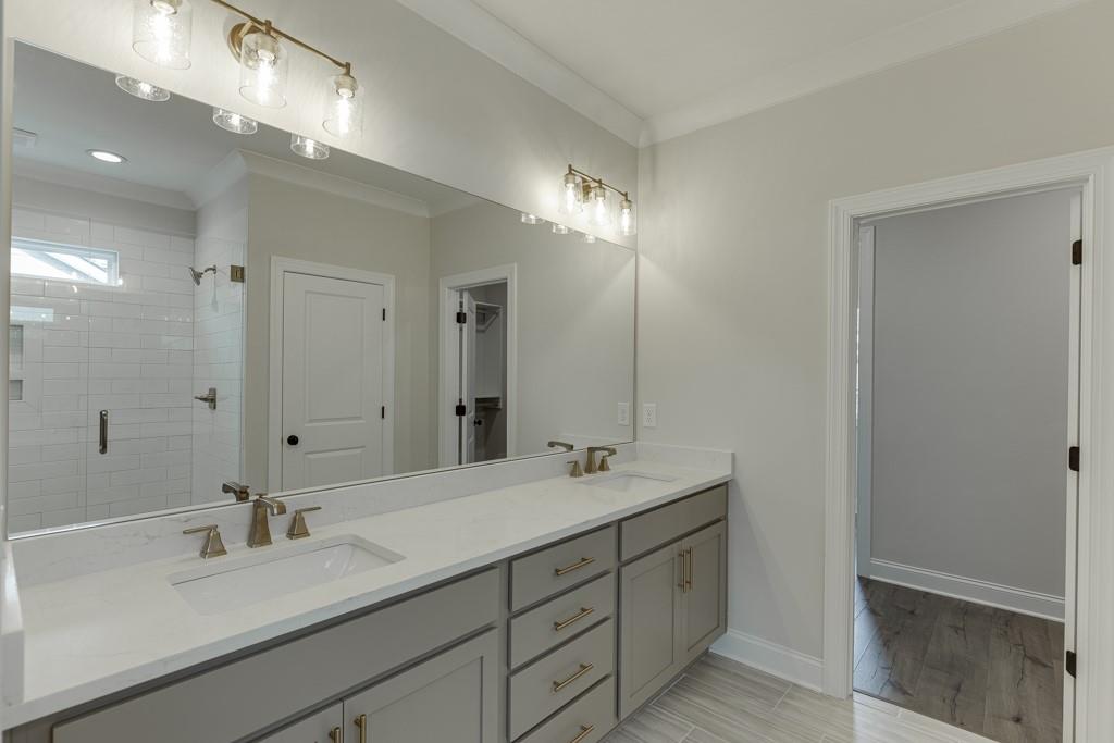 173 Swimming Pool Road Buford, GA 30518 - Photo 40 of 68 a bathroom with double vanity sinks and a mirror