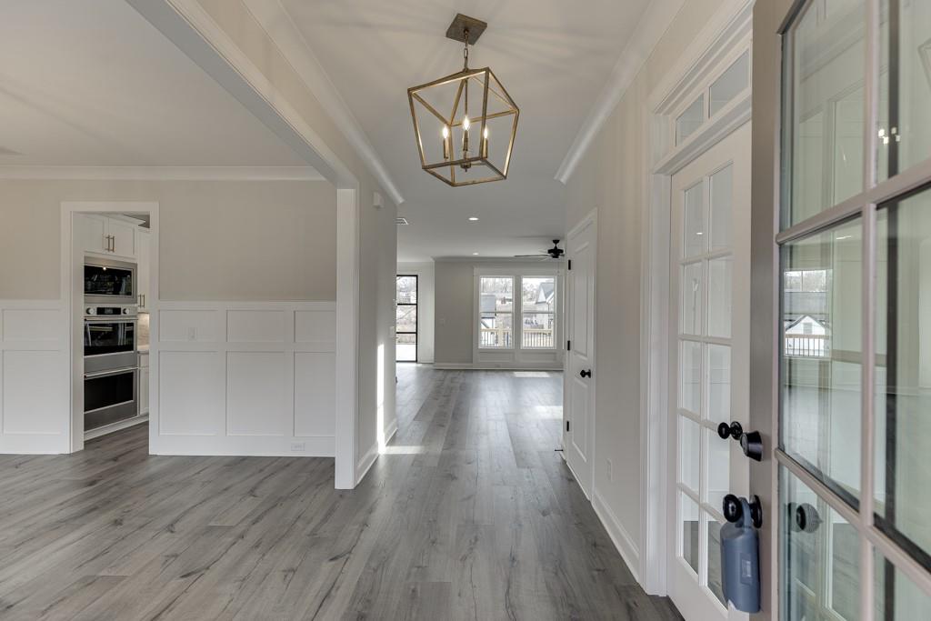173 Swimming Pool Road Buford, GA 30518 - Photo 4 of 68 a view of a hallway with wooden floor and staircase