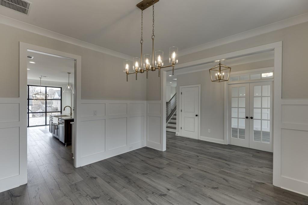 173 Swimming Pool Road Buford, GA 30518 - Photo 6 of 68 a view of a livingroom with a fireplace wooden floor and chandelier