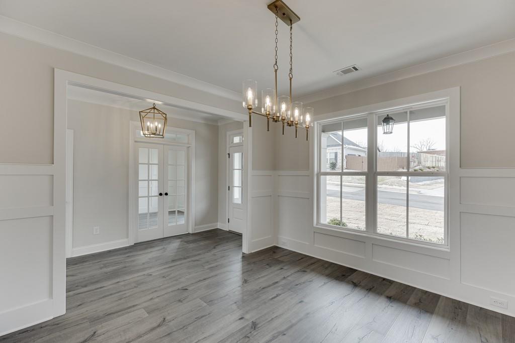 173 Swimming Pool Road Buford, GA 30518 - Photo 7 of 68 a view of an empty room with wooden floor and a window