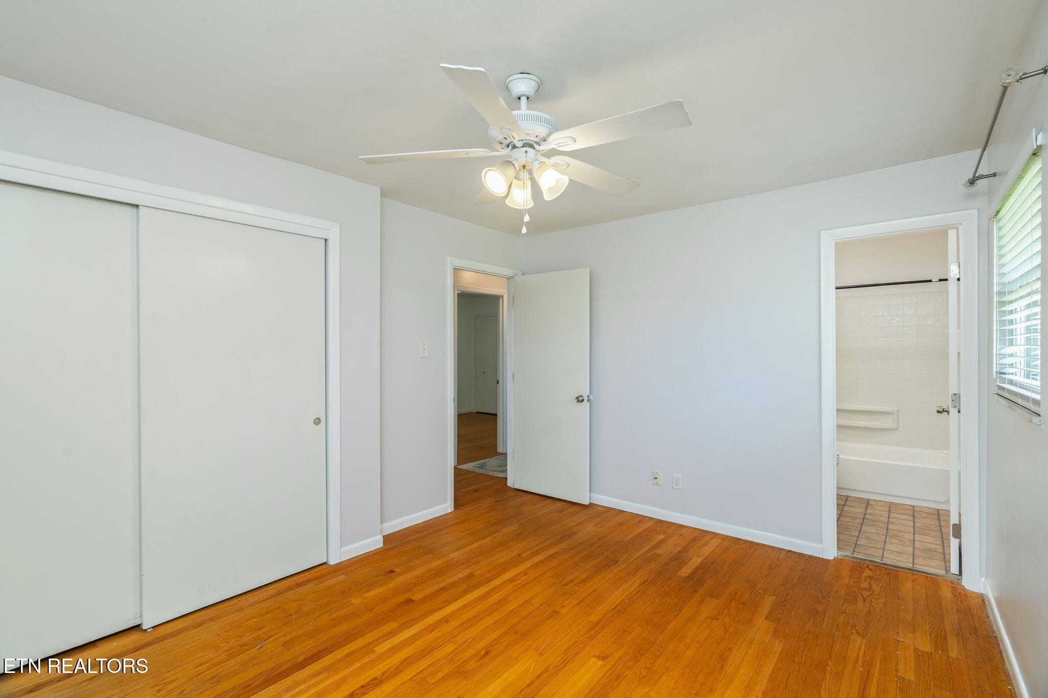 824 Noragate Road Knoxville, TN 37919 - Photo 16 of 29 a bedroom with a bed and a chandelier