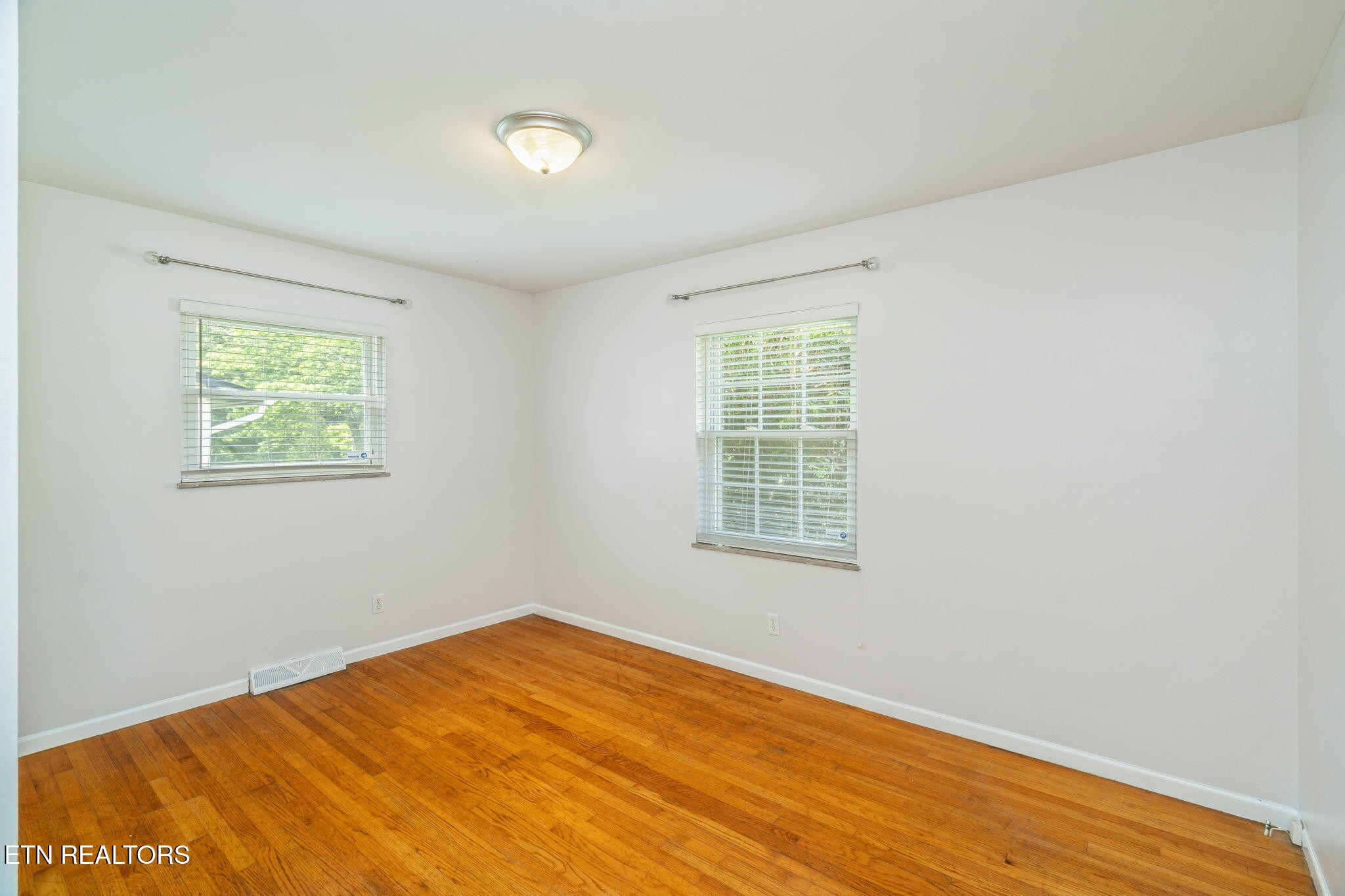 824 Noragate Road Knoxville, TN 37919 - Photo 18 of 29 a view of an empty room with wooden floor and a window
