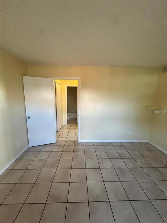 1627 West Oak Ridge Road, Unit D Orlando, FL 32809 - Photo 13 of 17 a view of a livingroom with an empty space and a window