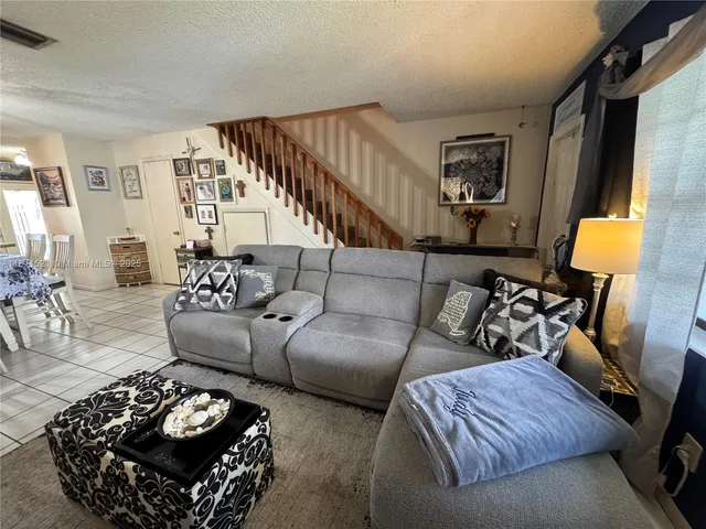 a living room with furniture and a lamp