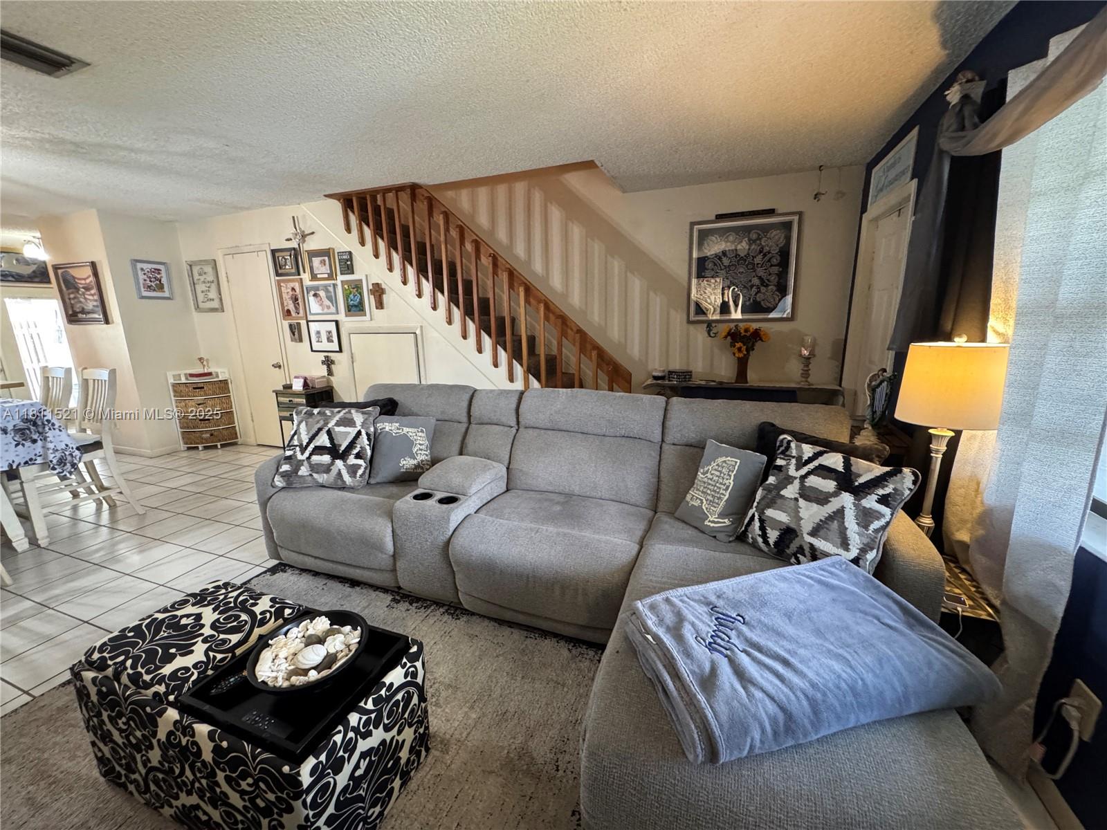 10428 Northwest 3rd Street Pembroke Pines, FL 33026 - Photo 11 of 30 a living room with furniture and a lamp
