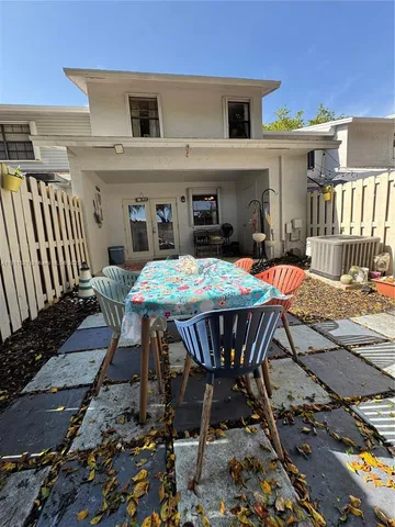 a view of a dinning table and chairs in the patio