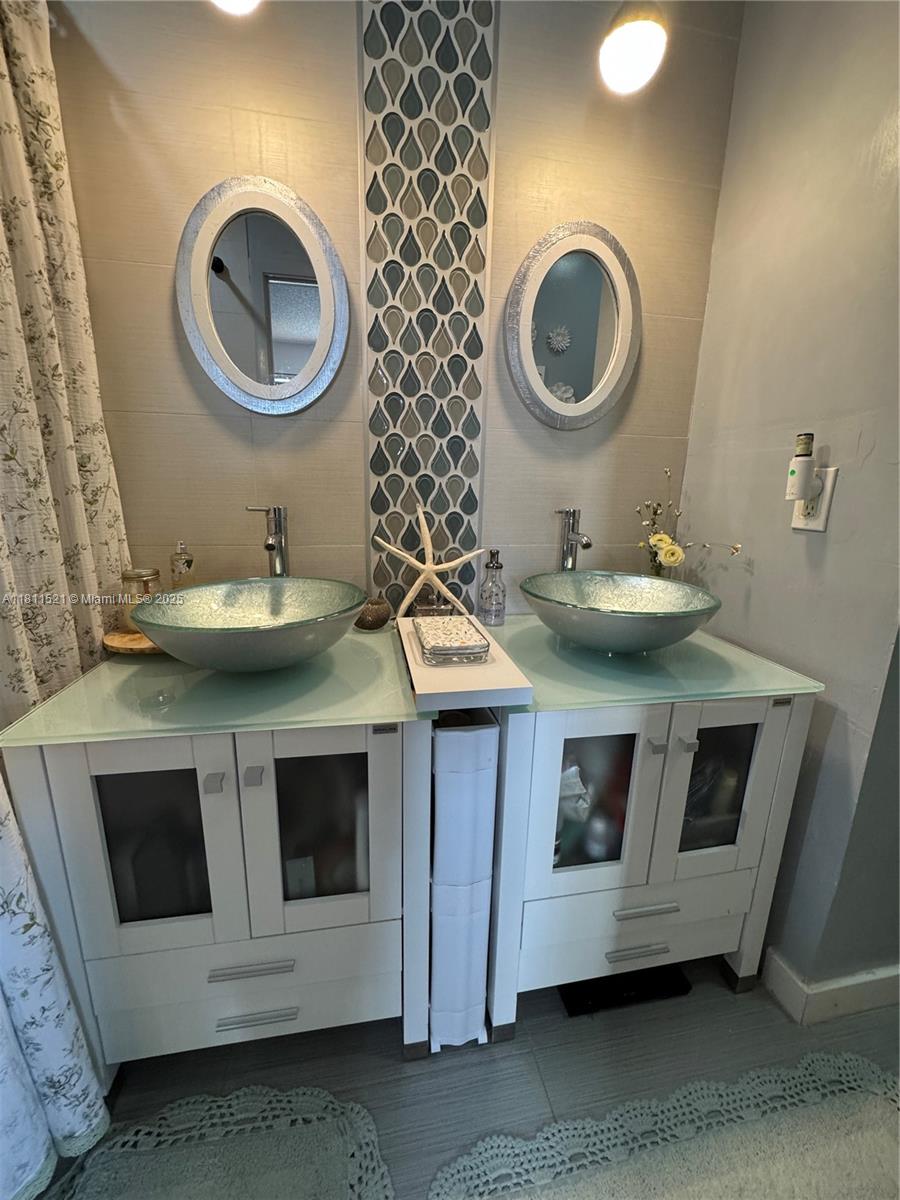 10428 Northwest 3rd Street Pembroke Pines, FL 33026 - Photo 20 of 30 a bathroom with a sink and a mirror