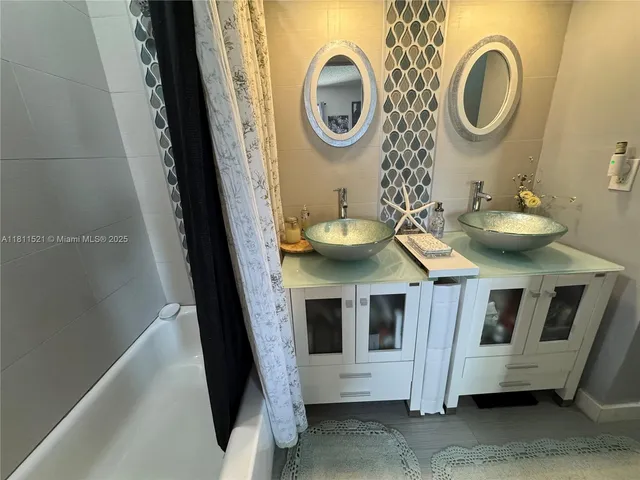 a view of a bathroom with a sink and a mirror