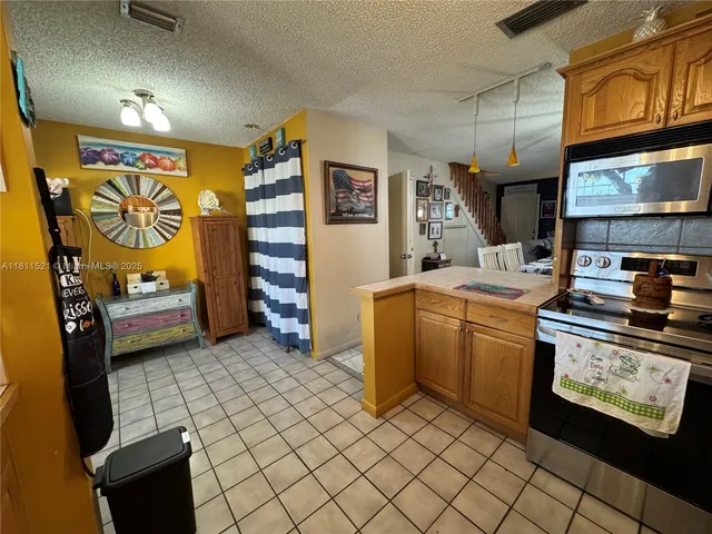 a kitchen with stainless steel appliances granite countertop a stove and a sink