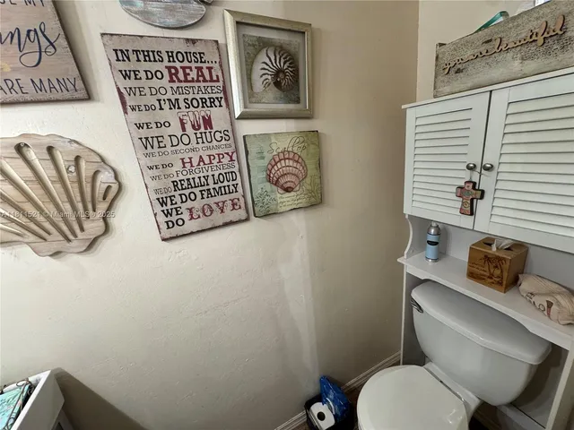 a bathroom with a toilet and a shower curtain