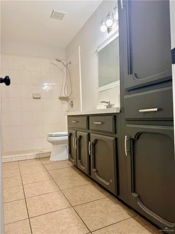 a bathroom with a sink a toilet and mirror