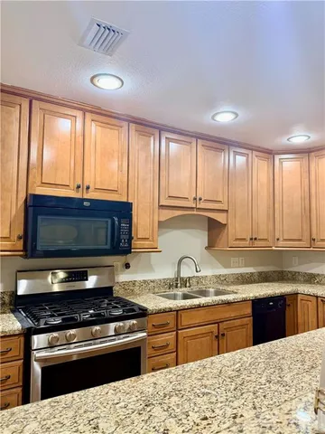 a kitchen with a stove a sink and a microwave