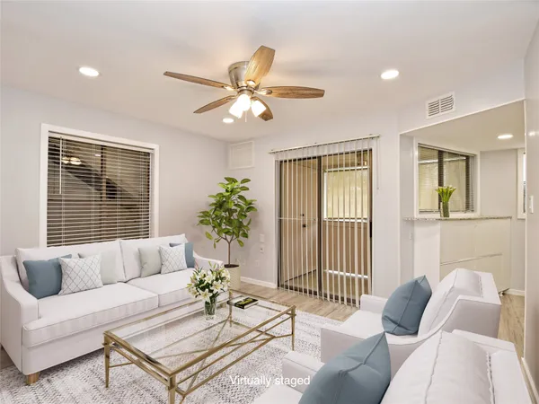 a living room with furniture and a large window