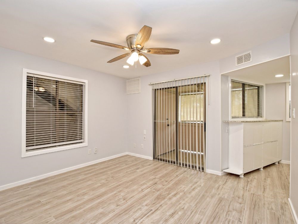 2500 Burleson Road, Unit 507 Austin, TX 78741 - Photo 3 of 14 a view of an empty room with a window and wooden floor