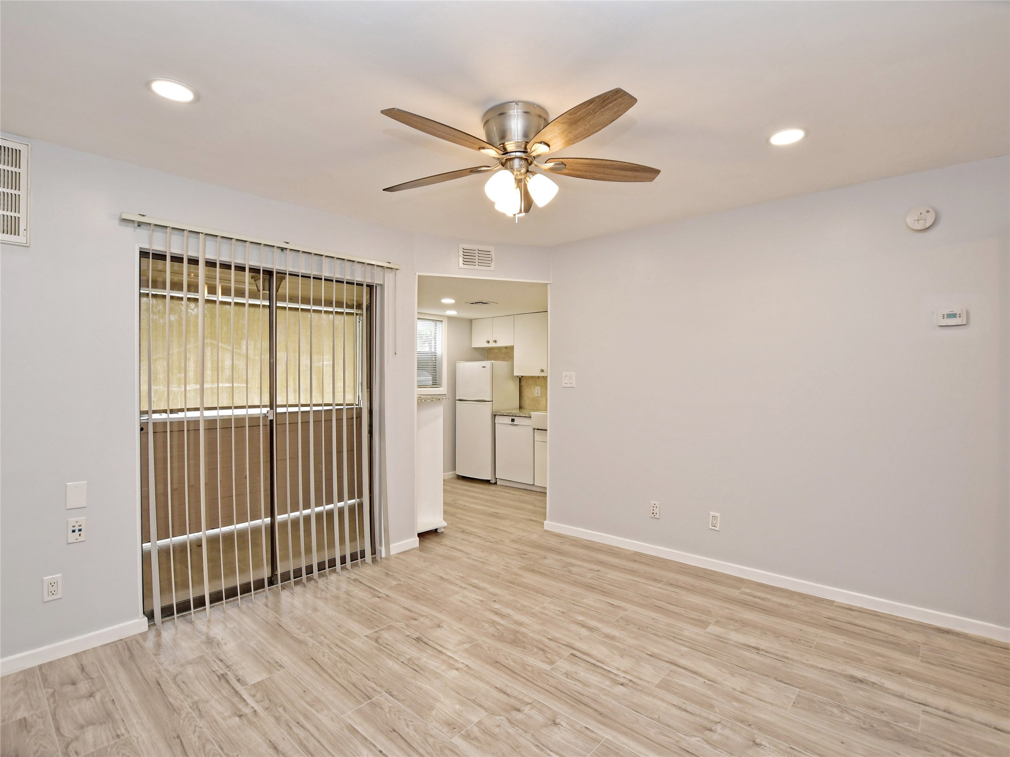2500 Burleson Road, Unit 507 Austin, TX 78741 - Photo 5 of 14 an empty room with wooden floor fan and windows