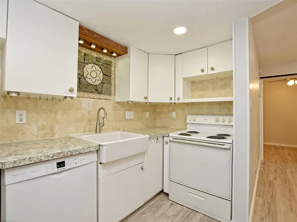 a kitchen with a sink stove and refrigerator
