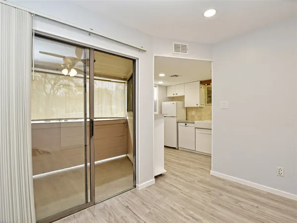 a view of a kitchen cabinets and wooden floor