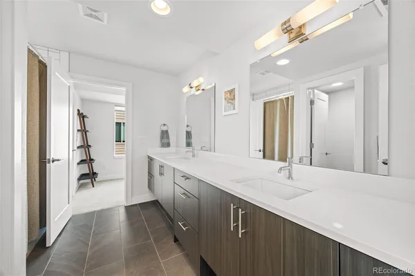 a spacious bathroom with a double vanity sink mirror and double