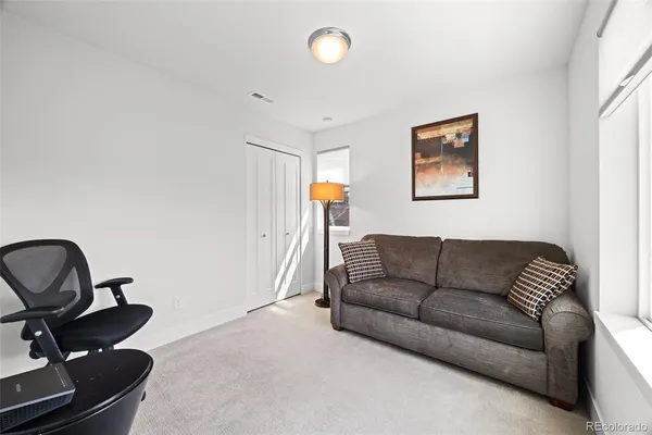 a living room with furniture and a piano