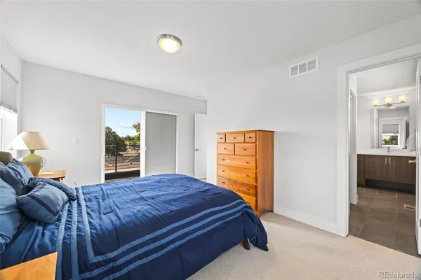 a bedroom with a bed and dresser