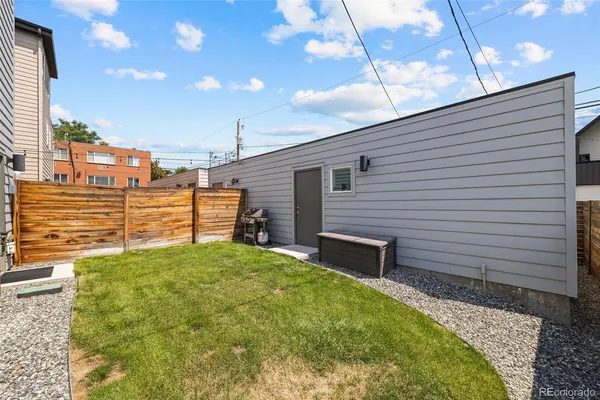 a view of a backyard with a small cabin and furniture