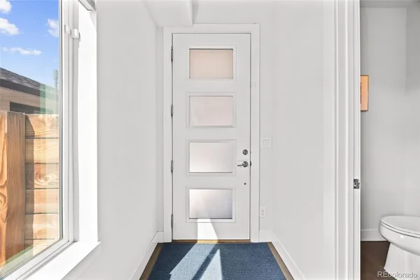 a view of a room with wooden floor cabinet and a bathroom