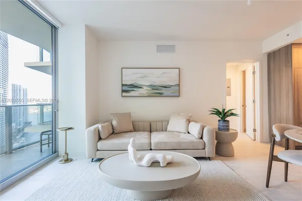 a living room with furniture and a large window