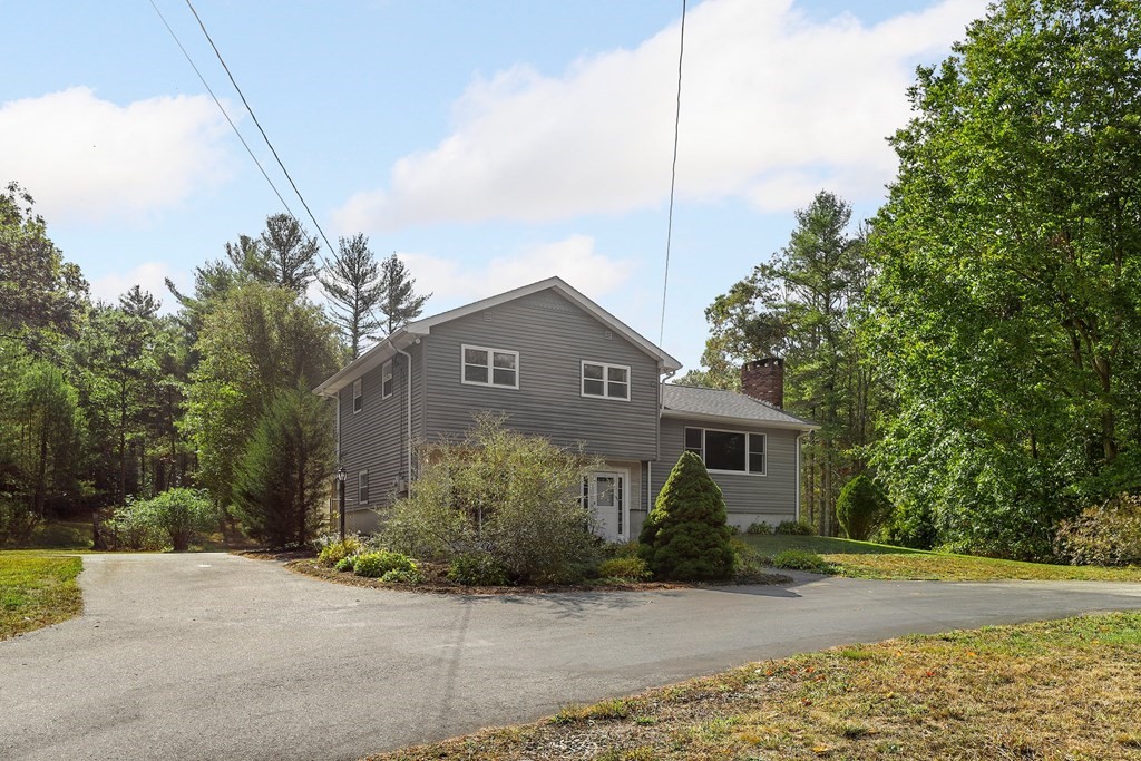 75 Chipaway Road Freetown, MA 02717 - Photo 3 of 34 a front view of a house with a yard and potted plants